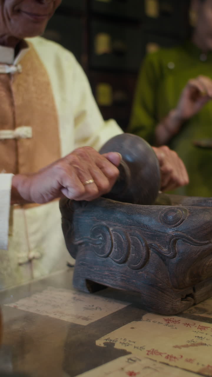 Unrecognizable Alternative Medicine Worker Grinding Herbs in Ancient Way