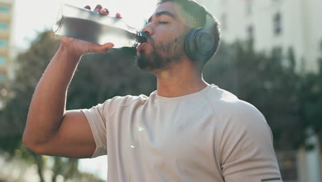 Fitness,-man-and-drinking-water-with-headphones