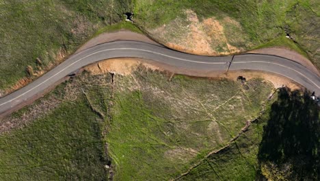 Birds-eye-view-of-winding-Road-through-green-hills,-Mount-Diablo-State-Park,-California