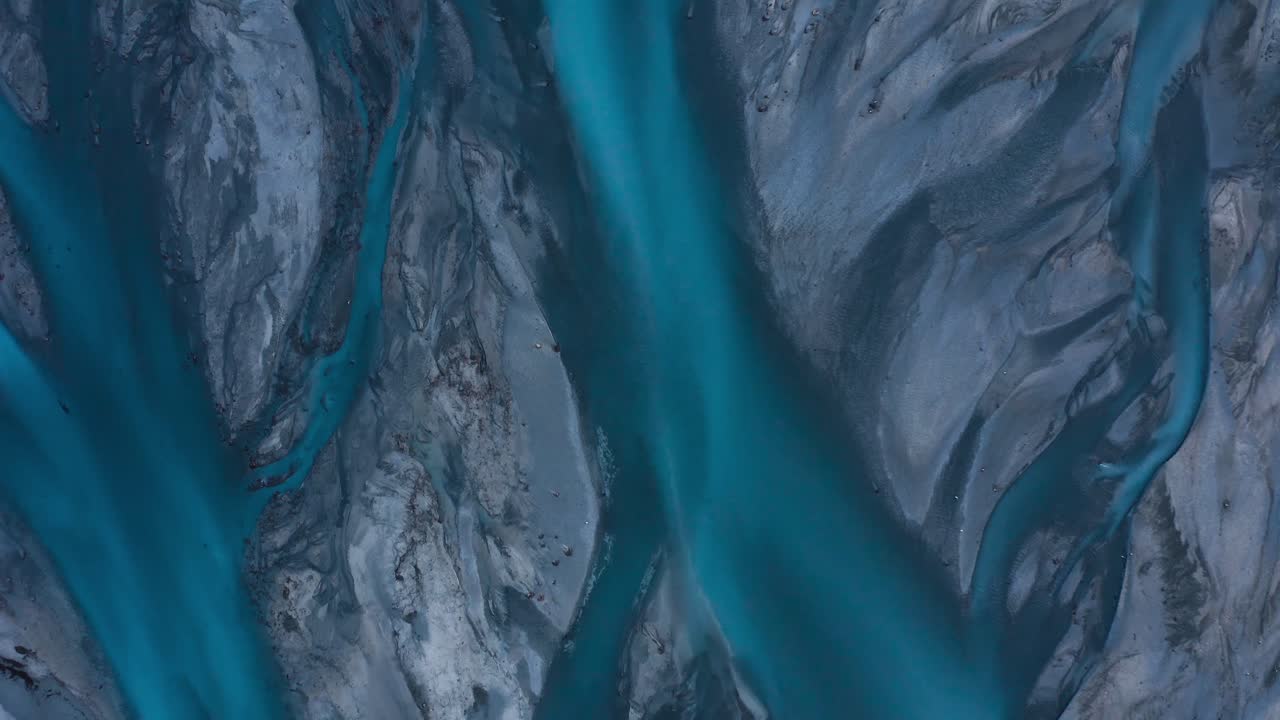 Top down aerial shot of Blue Glacial Braided River delta, water weaving like veins, Godley River, New Zealand