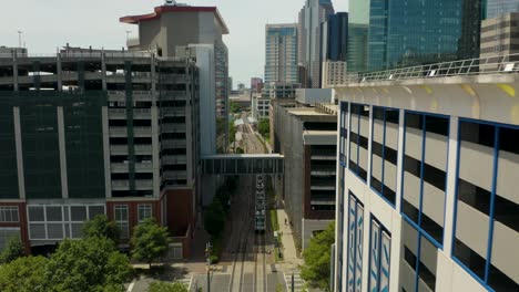 Aerial-Tracking-Shot-of-Light-Rail-Train-in-Downtown-Charlotte,-North-Carolina