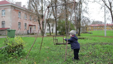 The-little-boy-is-swinging-an-old-swing