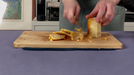 A-Japanese-female-chef-removes-kernels-from-the-corncob-at-home-kitchen,-Tokyo,-Japan