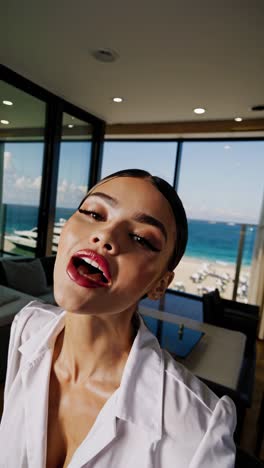 woman smiling in luxury apartment with ocean view