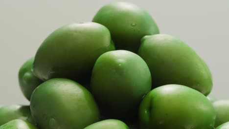 pickled round green olives from greece as background, top view. high quality 4k footage