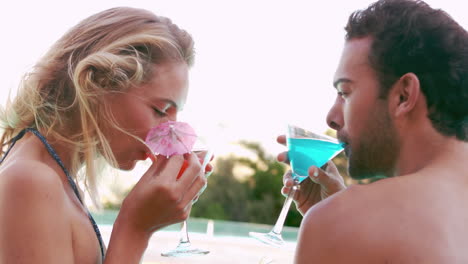 attractive couple relaxing by the pool