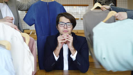 man choosing clothes in a cafe