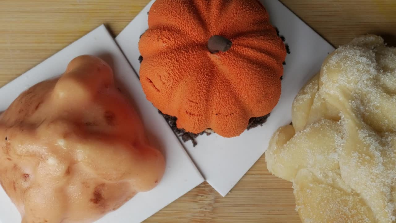 Colorful Halloween pastries with pan de muerto and pumpkin cake