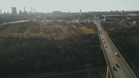 traffic over bridge near steel distributor plant in galati, romania. aerial drone shot
