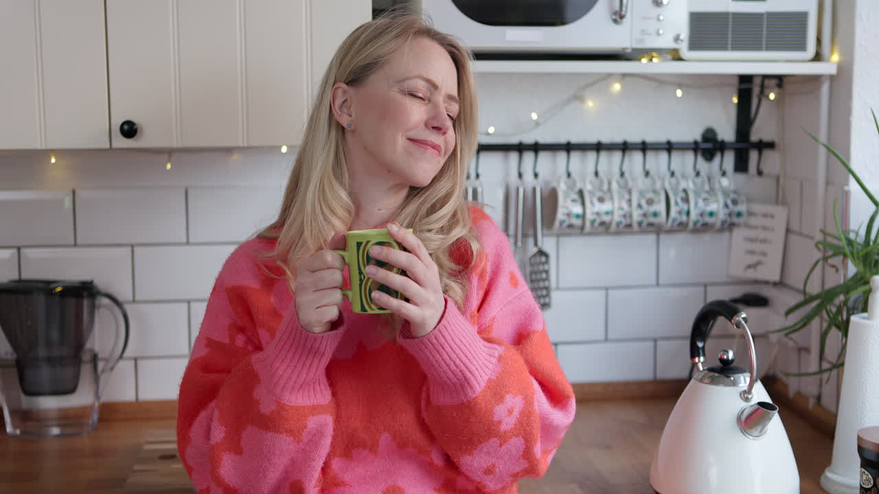 Woman in kitchen with mug