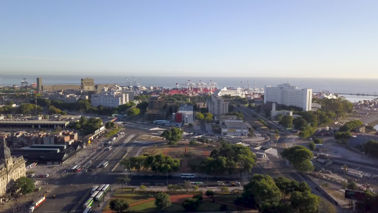 Aerial shot of Retiro railway station and Torre Monumental revealing the port of Buenos Aires