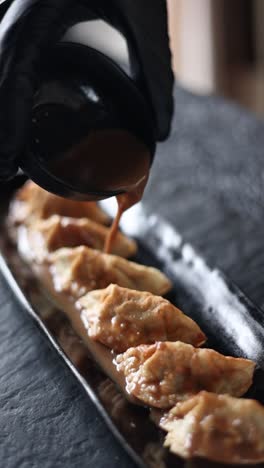 serving gyoza with sauce