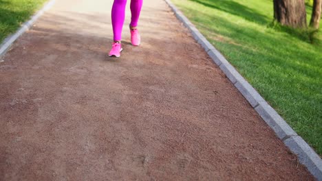 Runner-woman-running-in-the-park-exercising-outdoors,-close-up-on-feet.-Steadicam-stabilized-shot.-sports-women-training-in-the