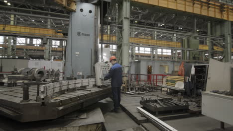 factory worker operating large machine