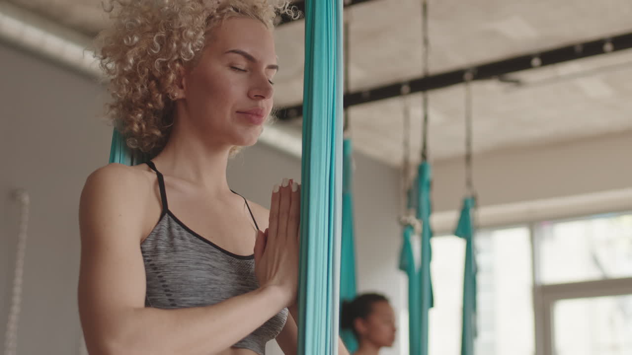 Woman Practicing Anti-Gravity Lotus Pose