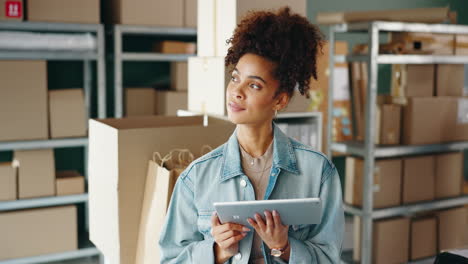 woman managing small business inventory with tablet in warehouse