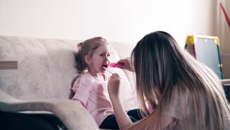 4k young attractive mother and sweet 2 daughter play the role of doctor and patient