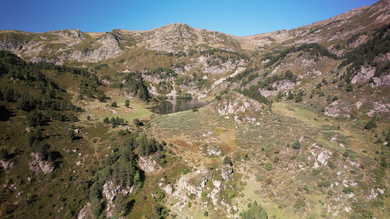 Aerial views of an alpine lake in the french Pyrenees at low altitude