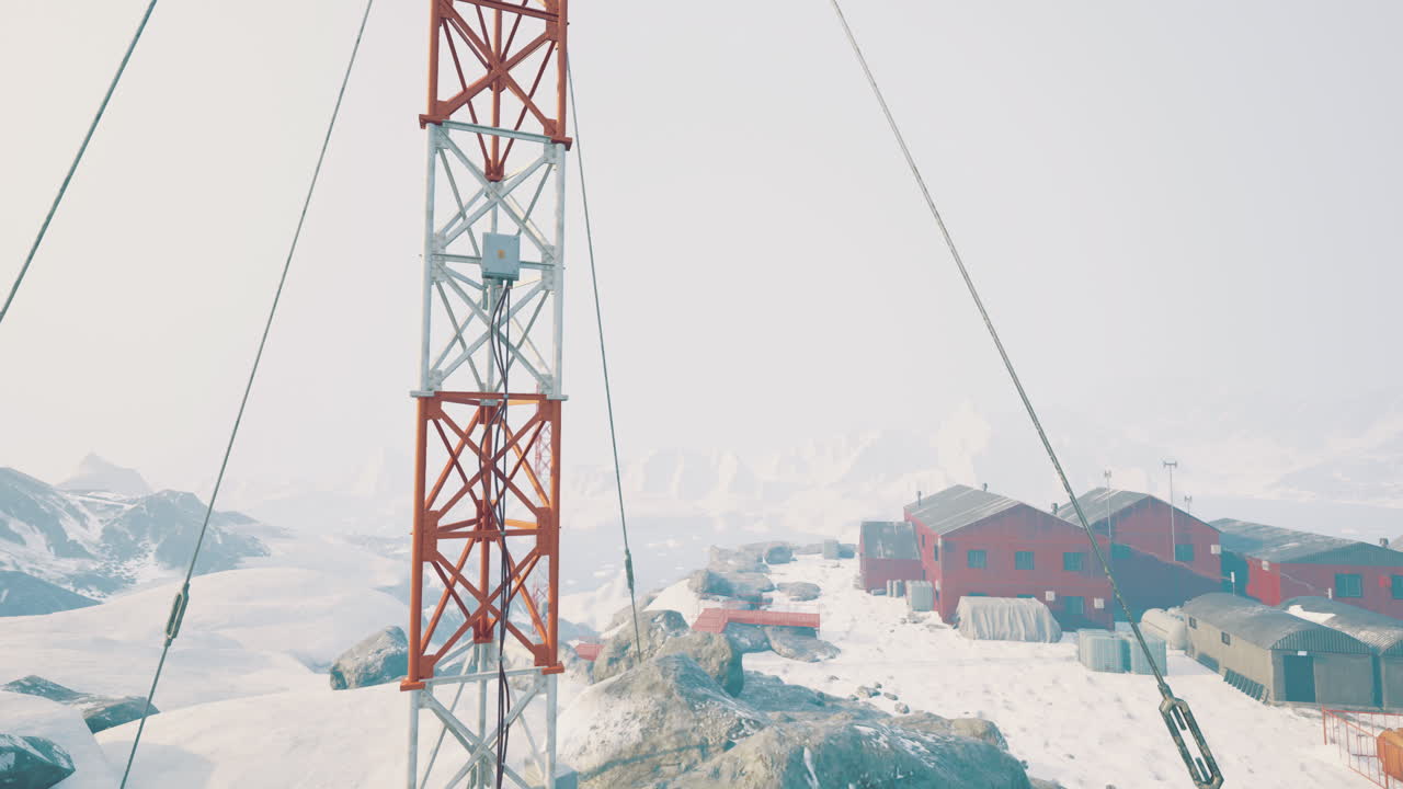 Winter landscape featuring communication tower near research station in snow