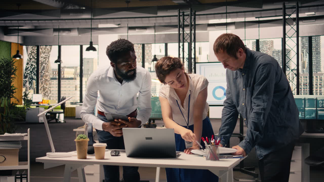 Business team collaborating in corporate office checking visual data