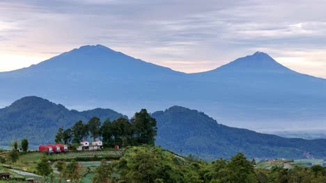 aerial scenery of house building on the hill with mountain background.