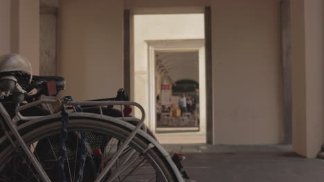 people pass and pass and this bicycle waits in the city of crema, italy