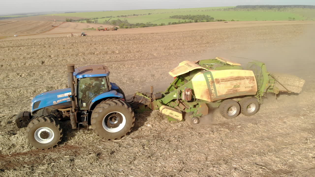 Sugar cane straw baler working in the field after harvesting the crop