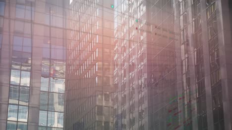 animation of multiple graphs and trading board over modern glass buildings in background