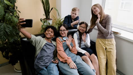 diverse group of happy teenagers taking a selfie together