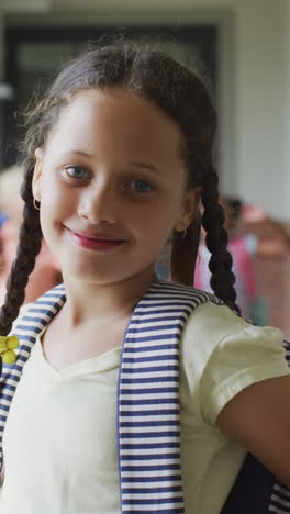 video of happy caucasian girl standing at school corridor