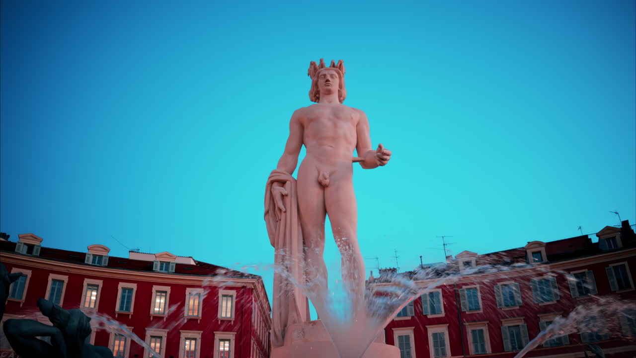 Nice, France - October 8, 2024: Apollo statue in the Fontaine du Soleil at Place Massena in the evening