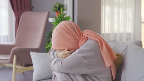 Muslim-Arab-teenage-girl-is-crying-and-sad-at-home.