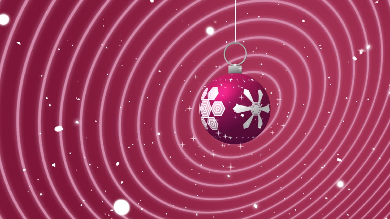 balancín de navidad rosa y blanco sobre la nieve que cae y anillos rosados concéntricos en movimiento