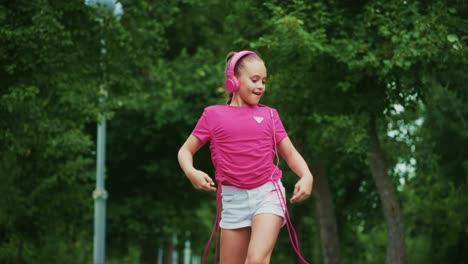 a young girl enjoys music while walking in a serene park, wearing stylish headphones and a bright outfit, capturing the joy of outdoor activities and youthful spirit
