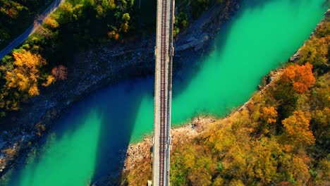 Stunning-aerial-4K-drone-footage-of-Solkan-arch-bridge-over-the-Soča-river,-a-majestic-stone-marvel-located-in-western-Slovenia