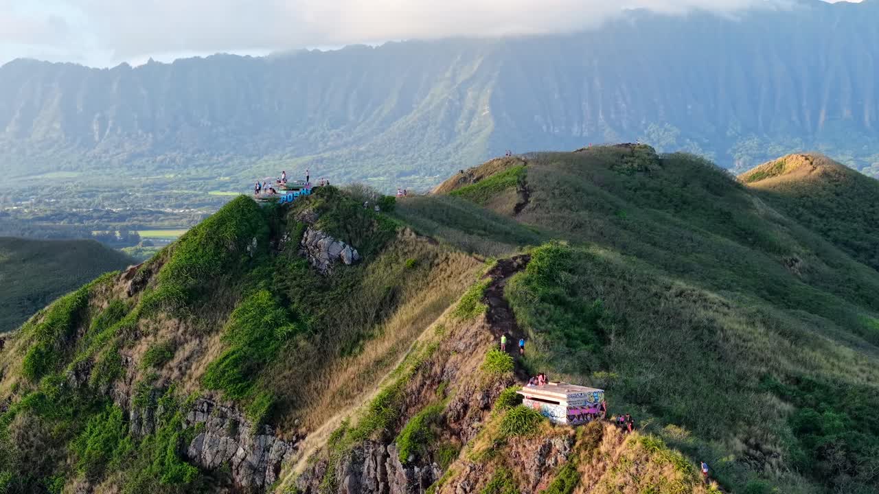 Tourists hiking the Lanikai Pillbox Trail on Kaiwa Ridge, Oahu, aerial flyover
