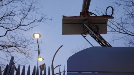 electric bus receiving renewable electricity at the bus station at dusk