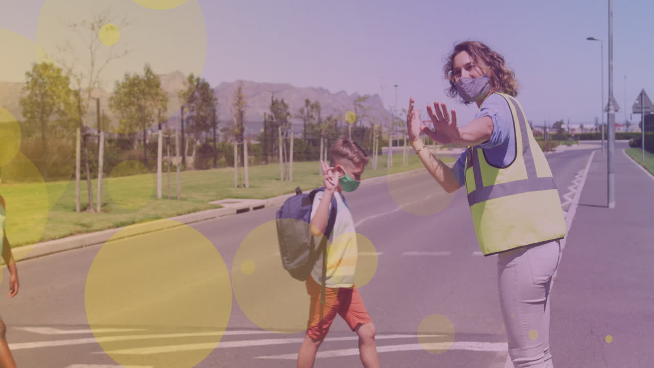 Animation of falling icons over happy caucasian boy crossing the street
