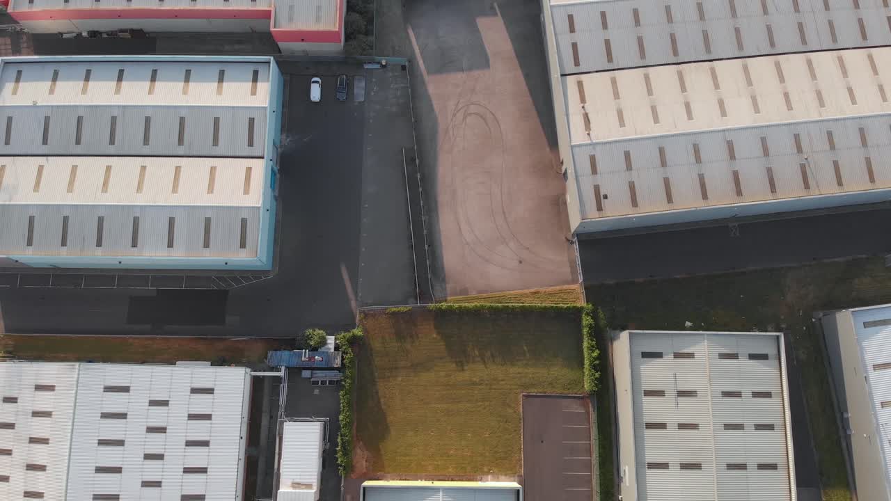 Warehouse Rooftops At Park West Business Park In Dublin, Ireland On A Sunny Day - aerial shot