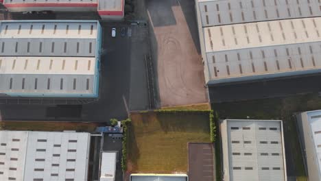 warehouse rooftops at park west business park in dublin, ireland on a sunny day - aerial shot
