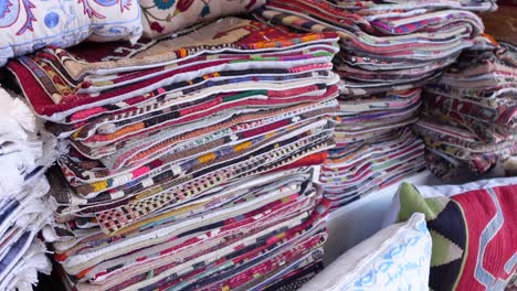 stacked colorful pillows and cushions