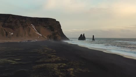 twilight reverie: drone flight over iceland's enigmatic black sand beach