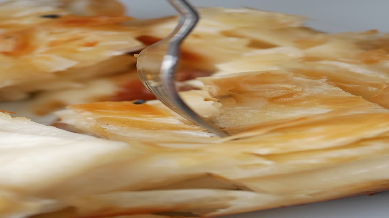Close up of baklava being eaten with a fork