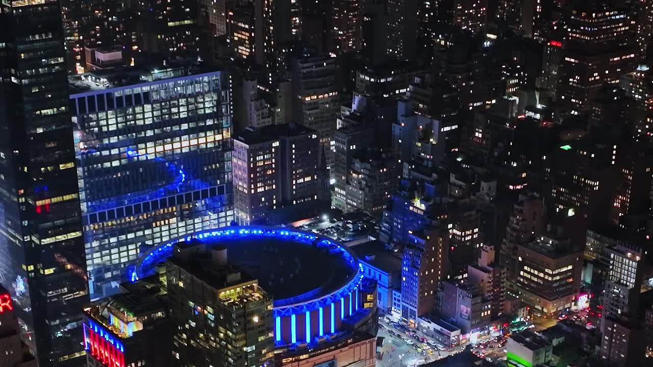 Night view of lit buildings in New York City from a drone perspective