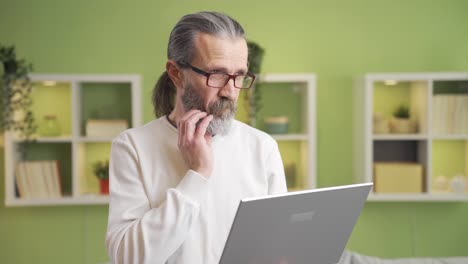 mature businessman working from home thoughtful and confused.