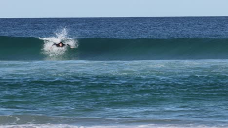 sequence of a surfer catching and riding a wave