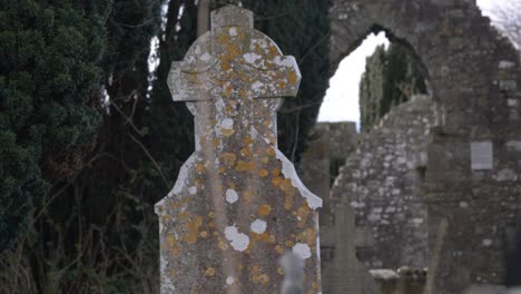 moss-covered gravestone at the ruins of st