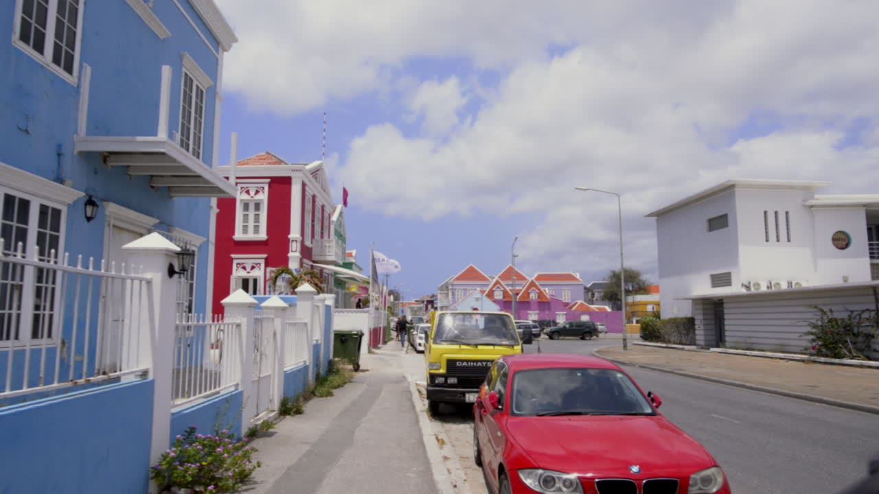 POV Walking in colorful streets of Willemstad, Curaçao. Sunny caribbean tropical cityscape with dutch architecture