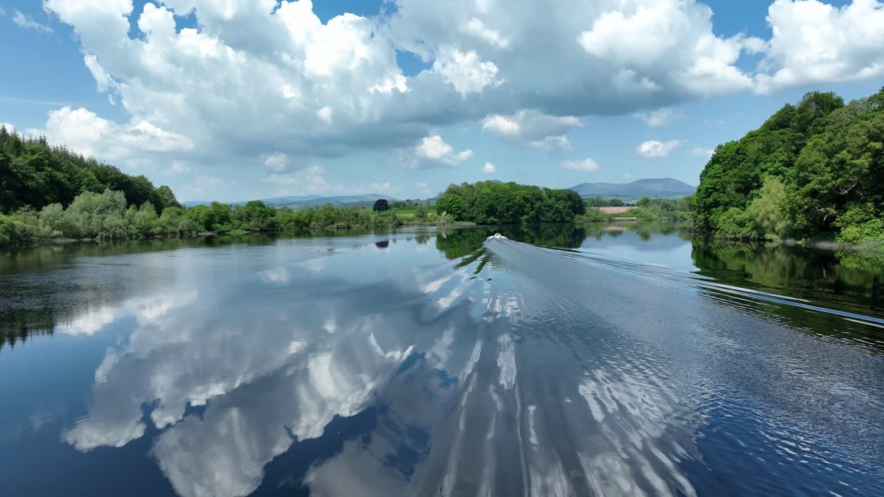 Ireland Epic locations drone chasing speedboat on Blackwater River on Waterford Cork border boat wake on salmon fishing river and beauty spot