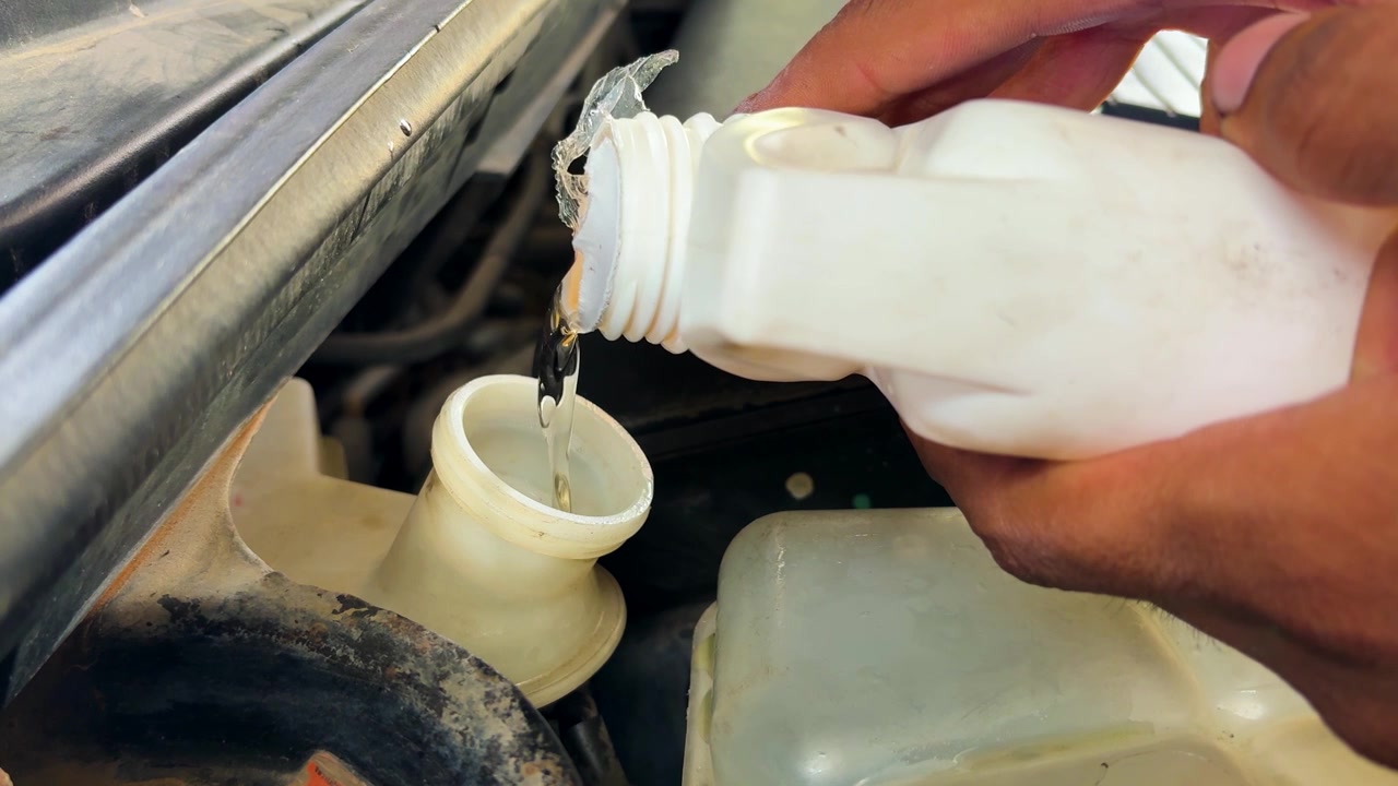 Close Up Of Brake Fluid Refill During Professional Automotive Service And Repair